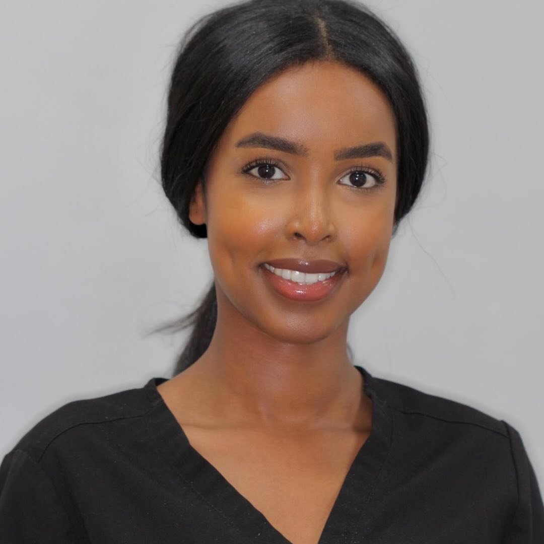 Dr Mariam Samra smiling in black scrubs